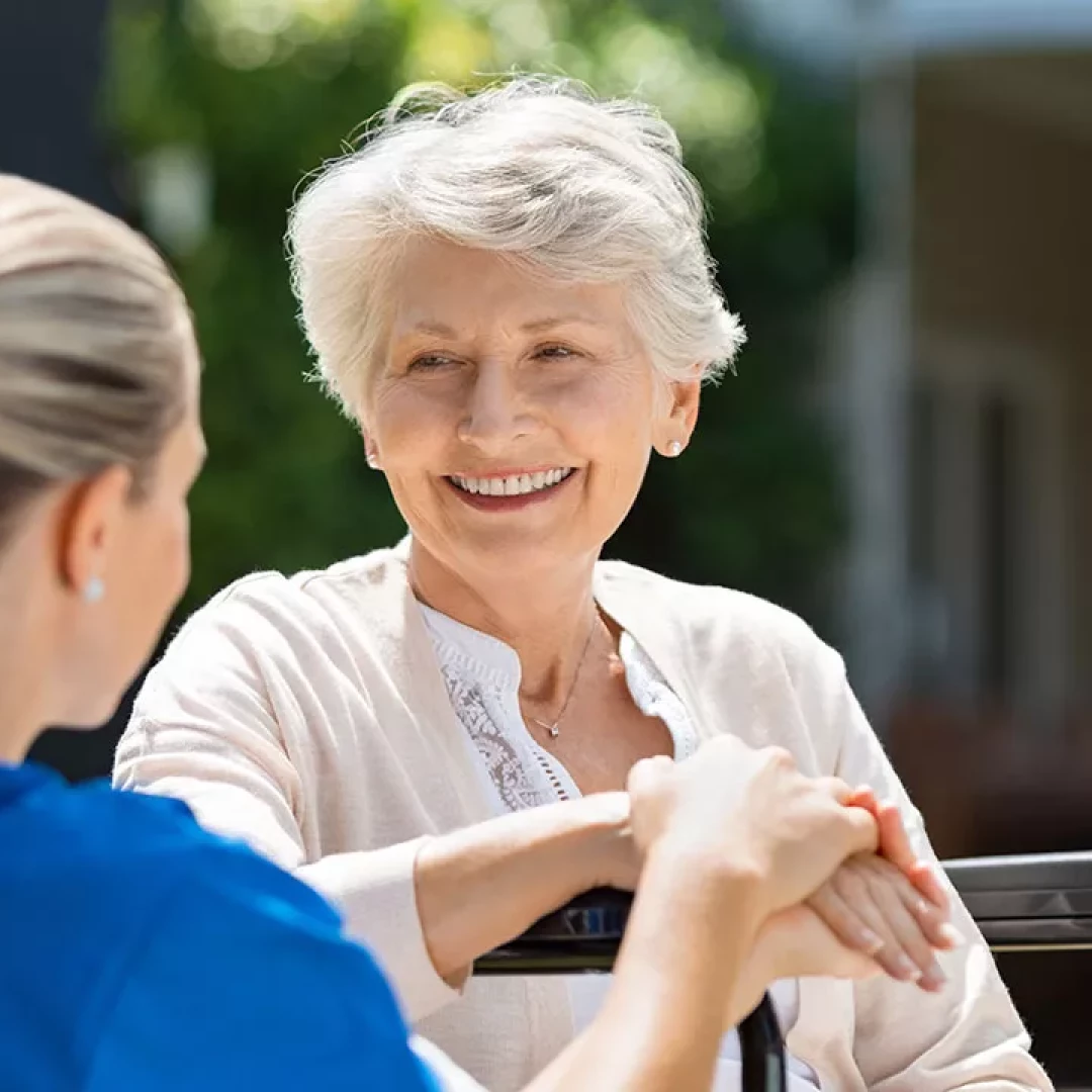 older woman chatting outside with a young woman