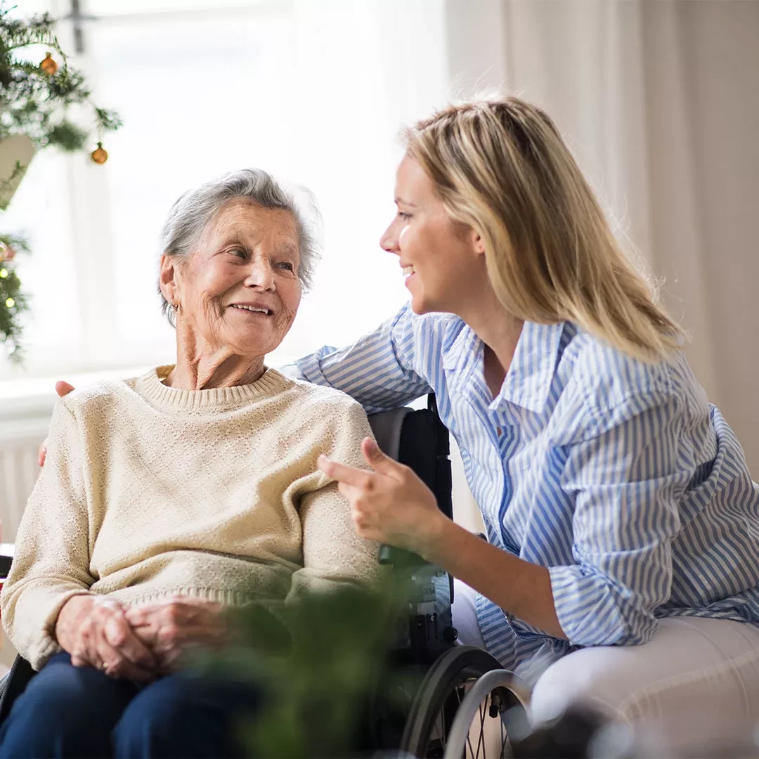 Caretaker with an elderly adult in a wheelchair