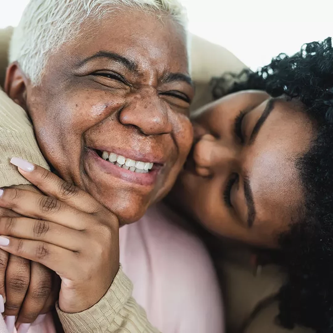 Daughter kissing her mom on the cheek