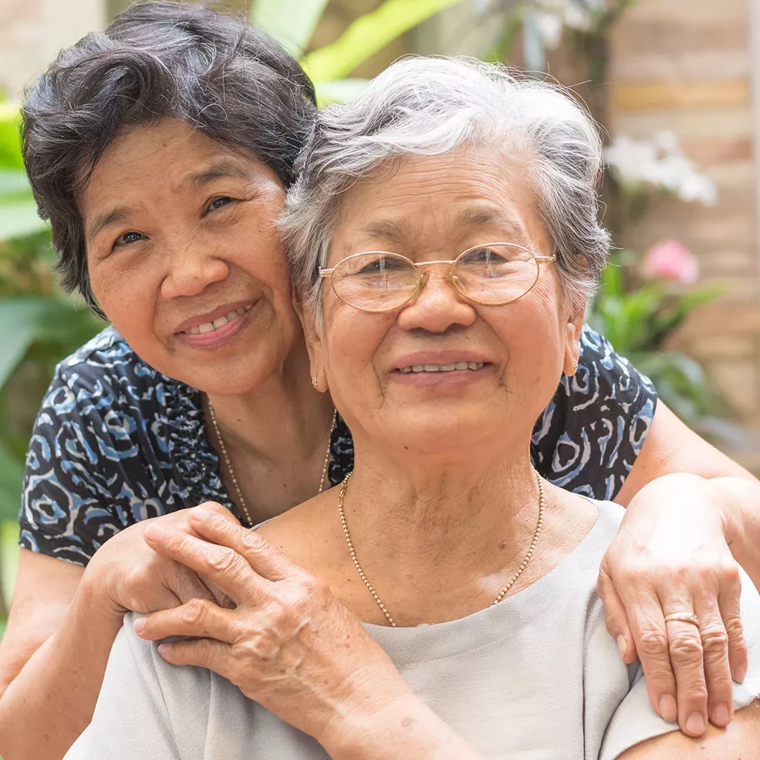 Older adults holding hands and smiling