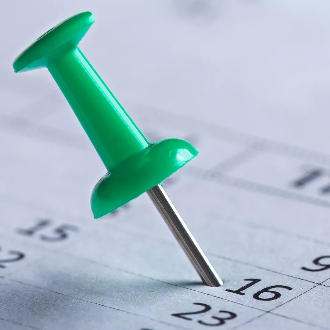 Calendar with pin stuck in a date