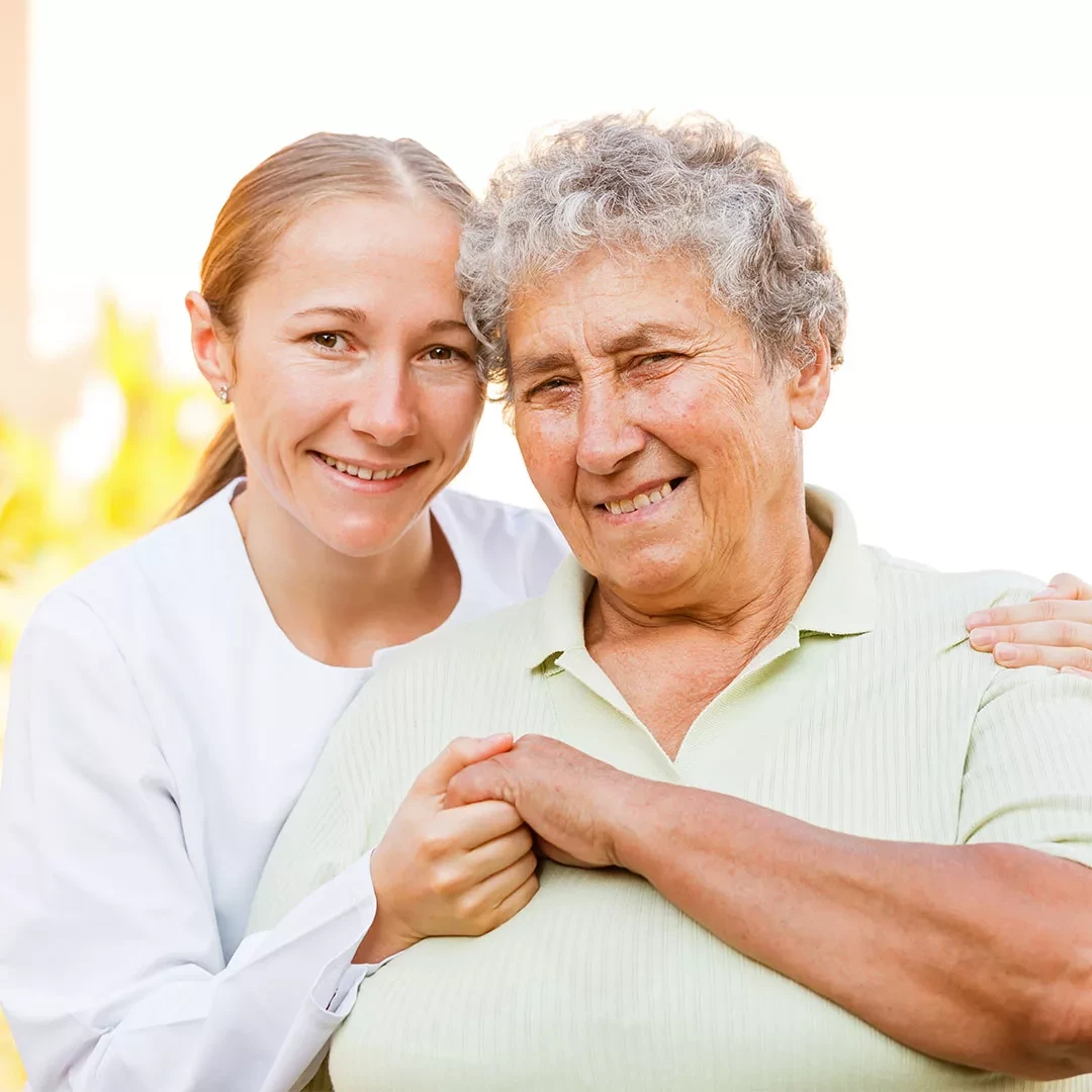 Caregiver holding hands with patient