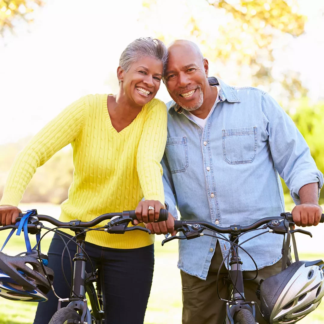 Two older adults riding bikes
