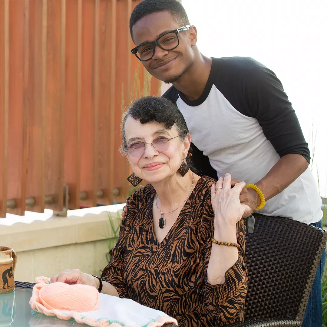 Older adult being helped by a younger adult