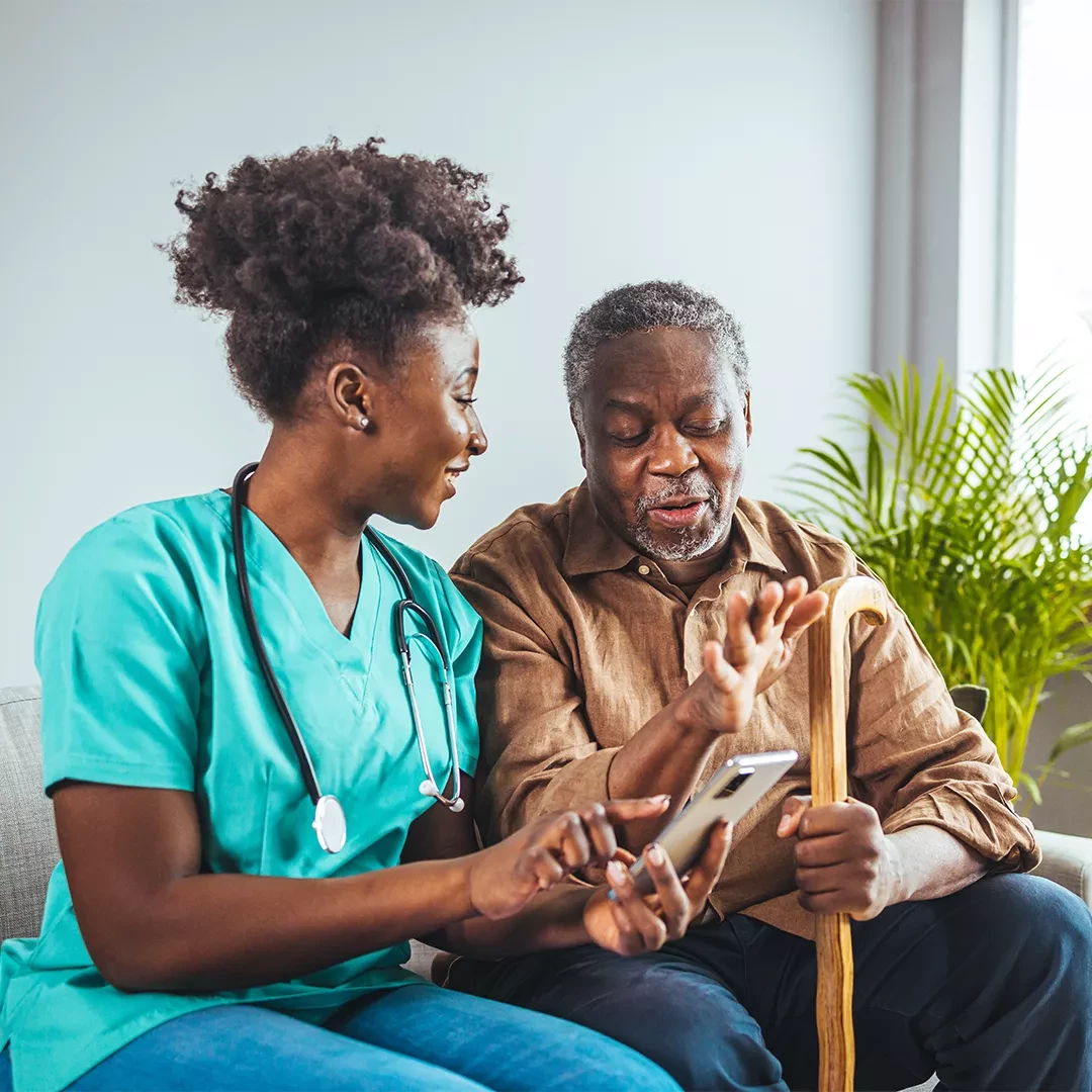 Patient with a cane talking to a nurse