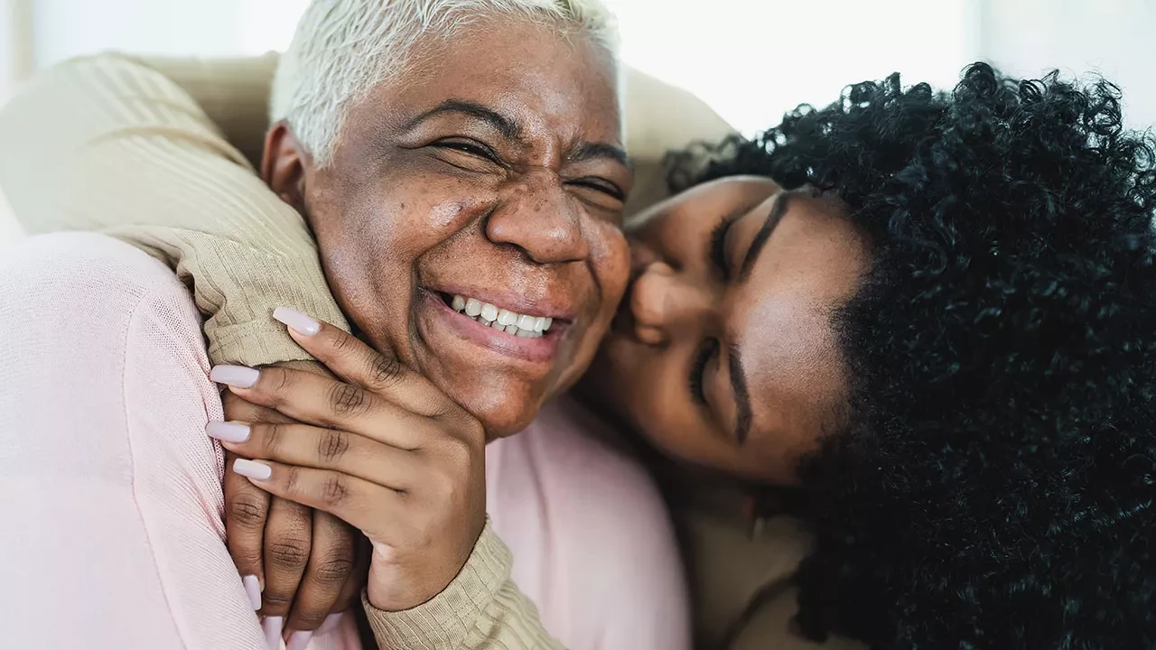 Daughter kissing her mom on the cheek